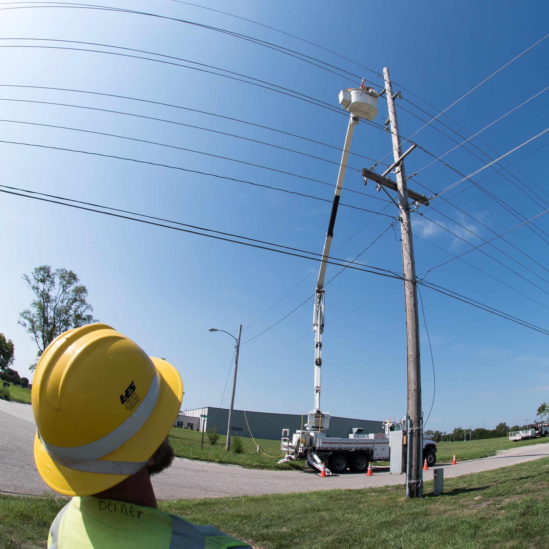 Watching lineworker on power pole