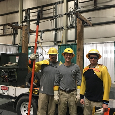 employees smiling with safety gear on