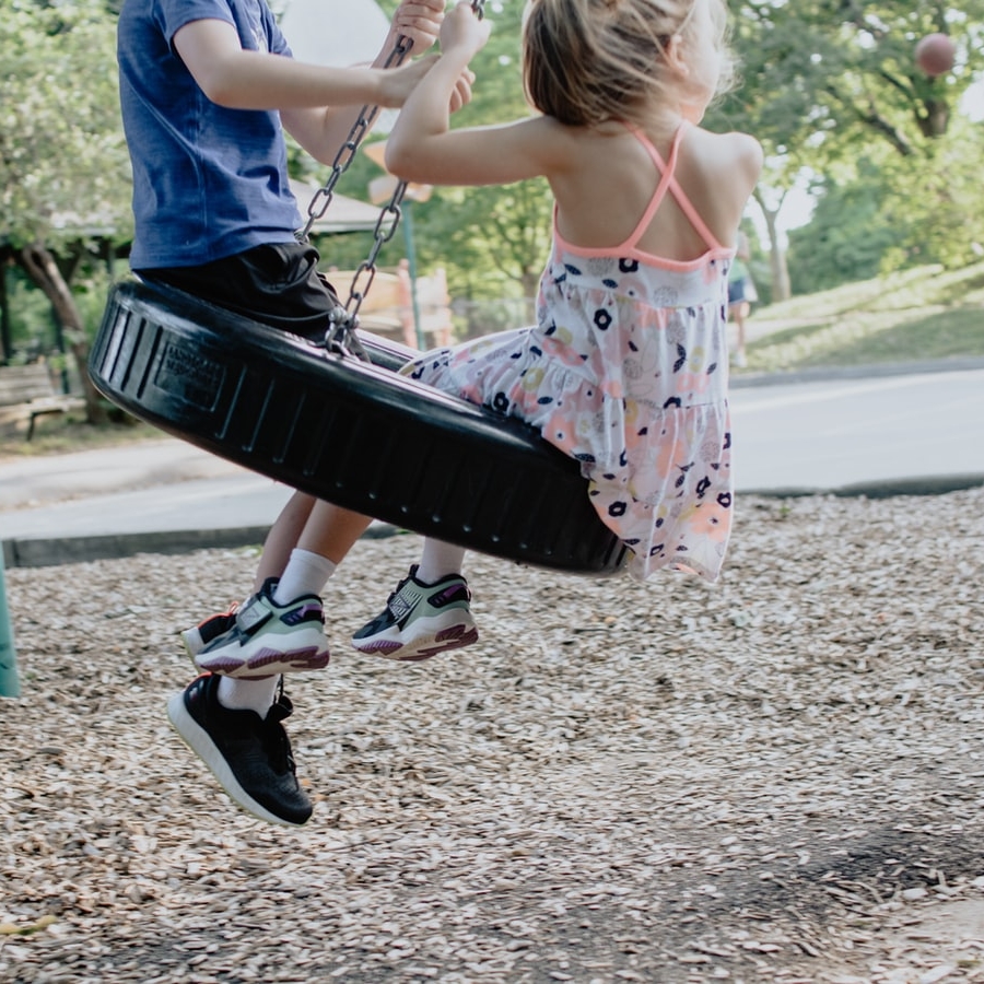 kids swinging on tire swing